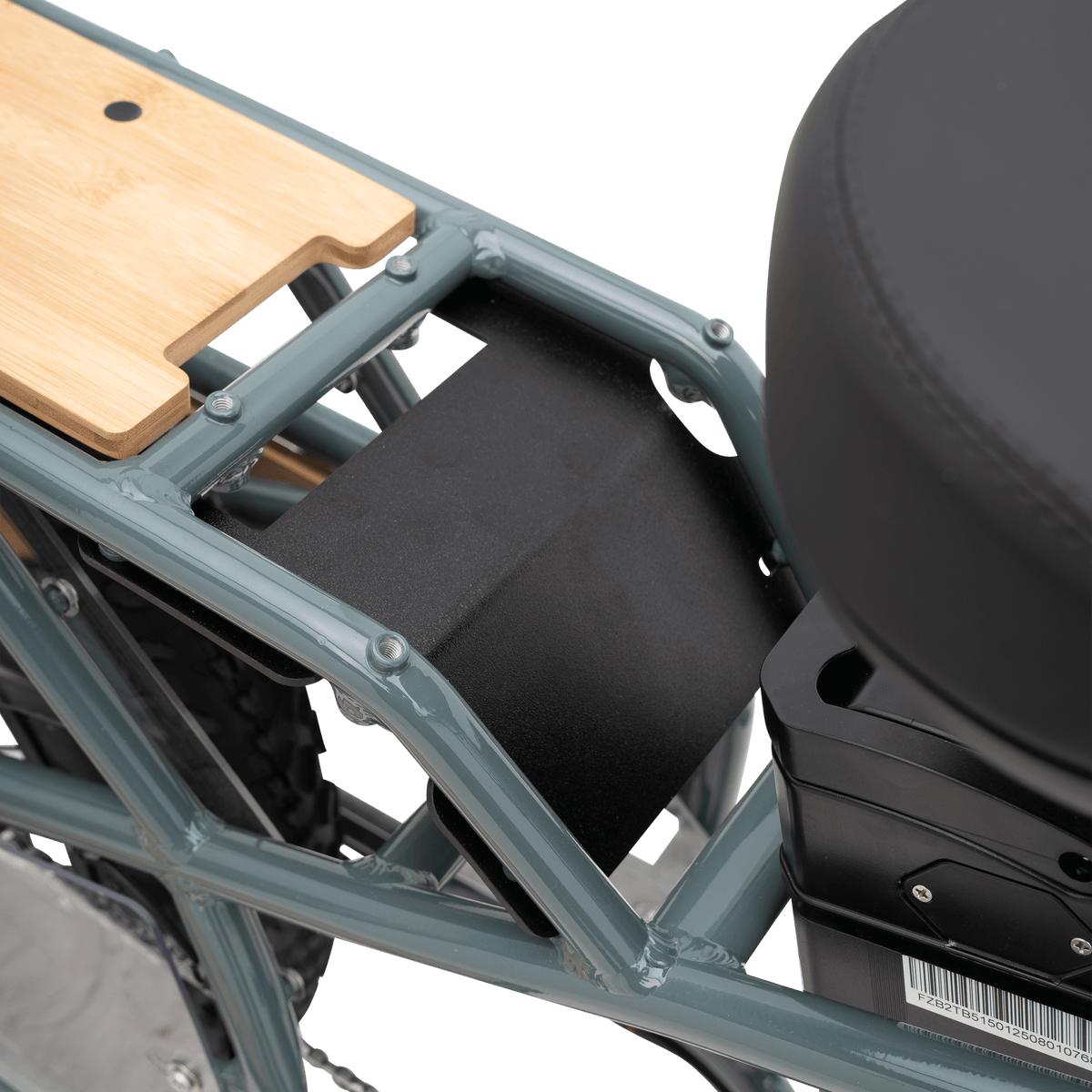 Close-up of the rear cargo platform and protectiveplate integrated with frame separating the rider seat from the rear platform with a wooden bamboo inlayed board