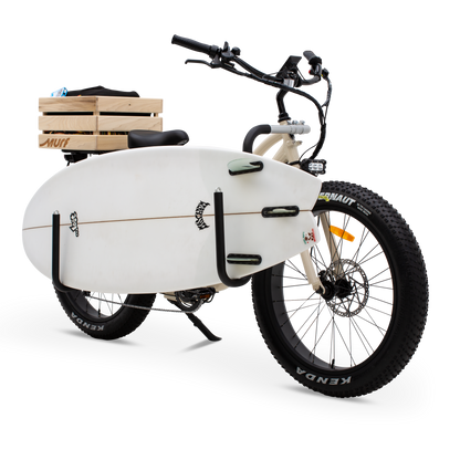  The Fat Murf Step-Thru in Bone White with a wooden crate attached to the back and white surfboard placed prominnetly withing the side mounted surf rack. on a white background