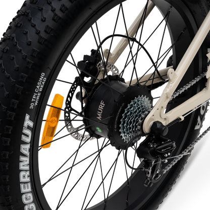 Close-up of a bicycle wheel with gear chain and rear hub motor mechanism on a white background