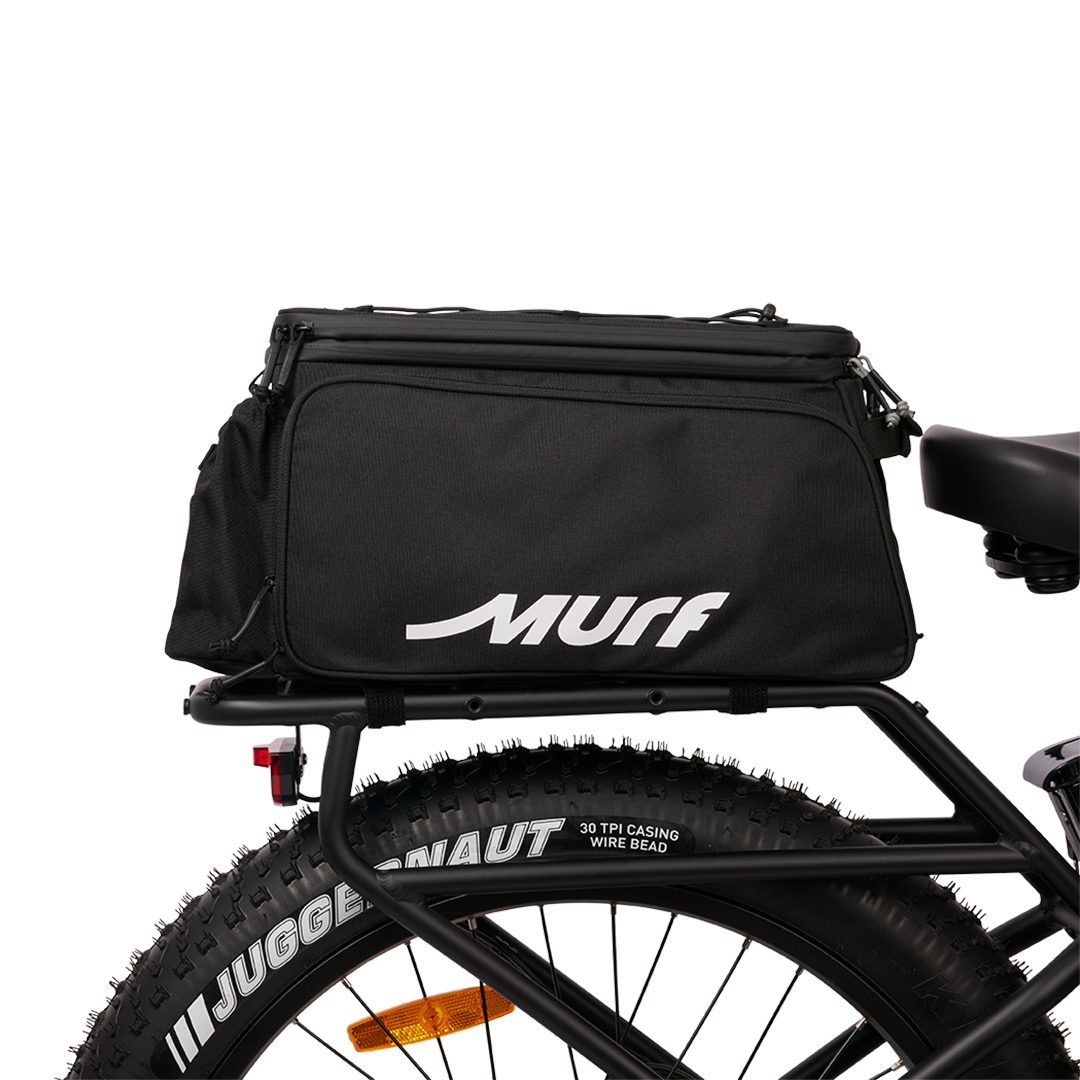 Murf Big Dawg Rack Bag mounted on the rear rack of an e-bike, viewed from the side, demonstrating secure attachment over the fat tire.
