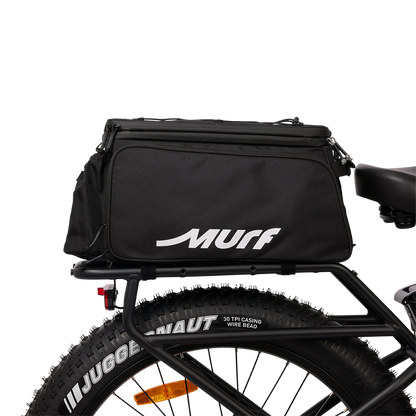 Murf Big Dawg Rack Bag mounted on the rear rack of an e-bike, viewed from the side, demonstrating secure attachment over the fat tire.
