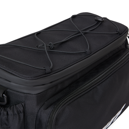 Close-up view of the top of the Murf Big Dawg Rack Bag, highlighting the bungee cord straps for securing extra lightweight gear.