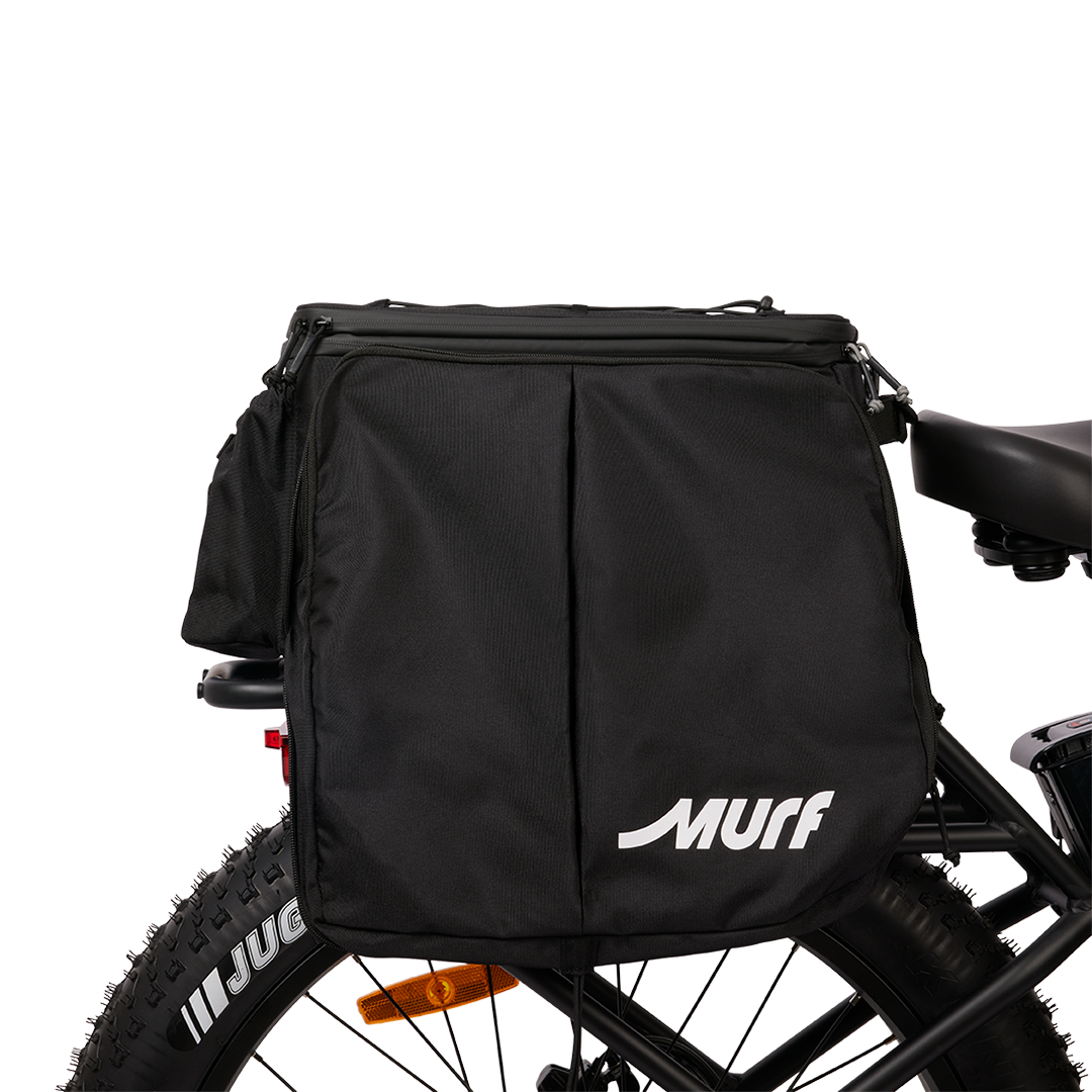 Side view of the Murf Big Dawg Rack Bag mounted on an e-bike, featuring the large MURF logo and the vertical pannier folds, demonstrating the cargo capacity.