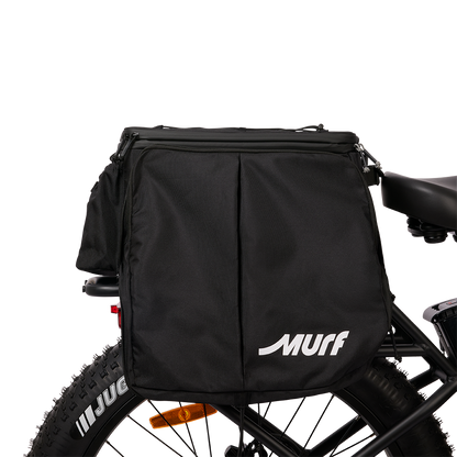 Side view of the Murf Big Dawg Rack Bag mounted on an e-bike, featuring the large MURF logo and the vertical pannier folds, demonstrating the cargo capacity.