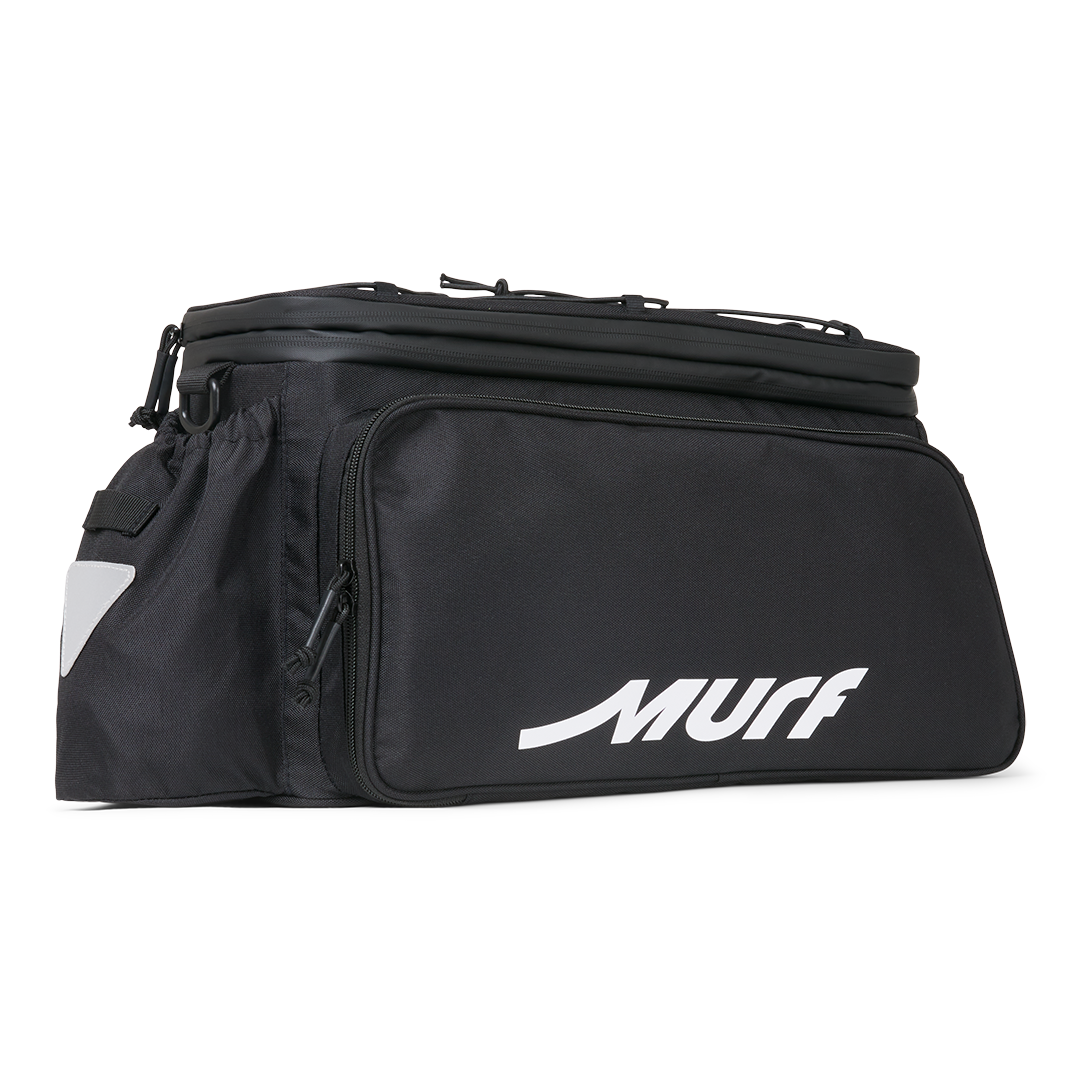 Murf Big Dawg Rack Bag product photo, black with white "MURF" logo, showing the main compartment and a side pocket with reflective triangle.