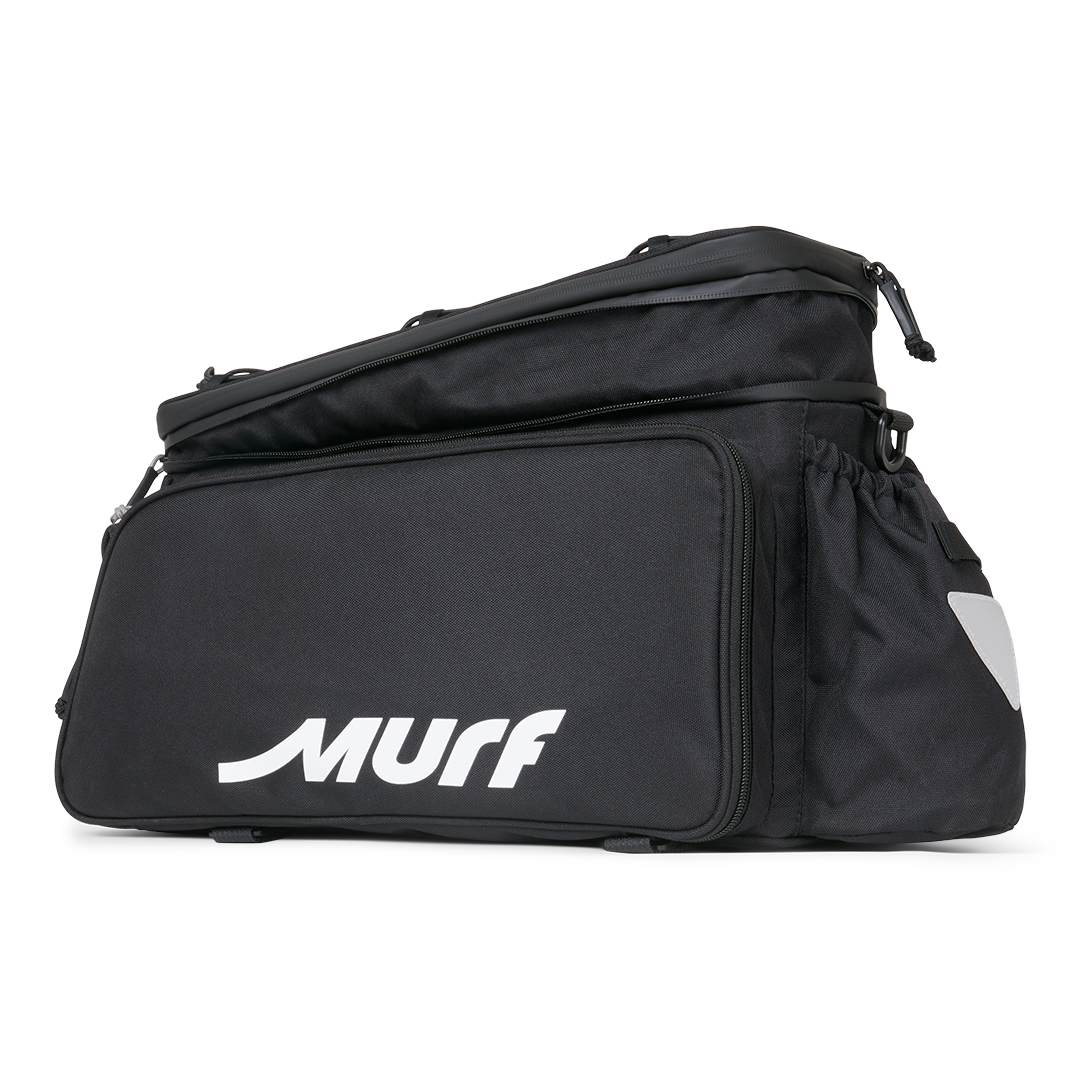 Side view of the Murf Big Dawg Rack Bag, featuring the main zipped compartment, the cinch-down side pocket, and the reflective safety triangle.