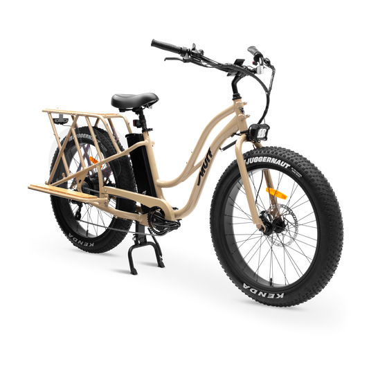 Desert Sand Gloss Alpha Cargo Class 2 Electric Utility Bike three-quarter studio view with bamboo platform

