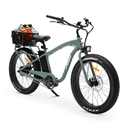 Sea Breeze Green electric bike with a basket filled with rear basket ball and pair of shoes on a white background