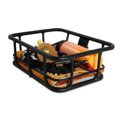 Murf Front Basket loaded with beach essentials including a towel, sunscreen, water bottle, keys, and a Kryptonite lock, demonstrating secure transport of small daily items.