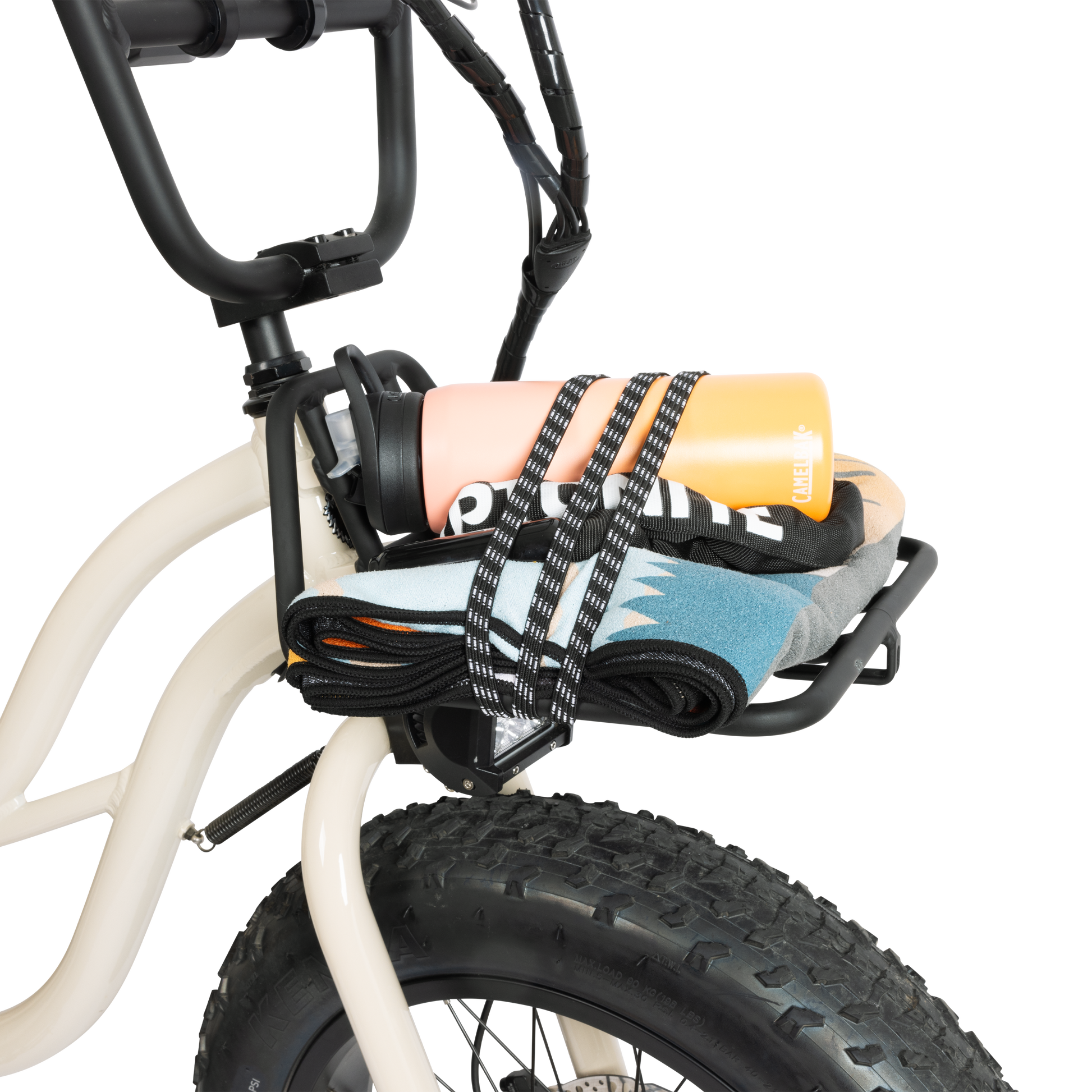 Murf Front Rack mounted on a cream-colored e-bike and loaded with a peach water bottle and colorful clothing items, demonstrating the use of the bungee straps for securing lightweight cargo.