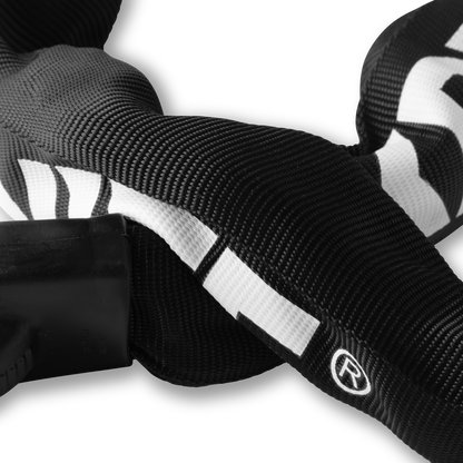 Extreme close-up of the durable weather-resistant black nylon sleeve covering the Kryptonite Keeper chain lock, showing the weave and a white graphic detail.