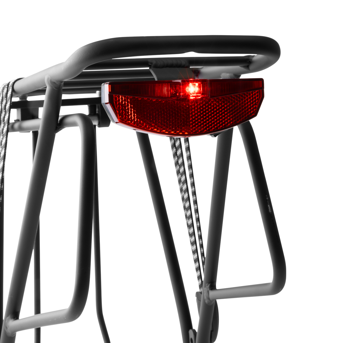 Close-up view of the Murf Rear Rack's integrated rear tail light, showing the bright red LED illuminated for visibility and road safety.