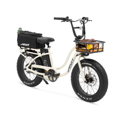 A 3/4 view of the Higgs step-through in bone white, featuring a front basket and rear rack with a securely fastened storage bag.