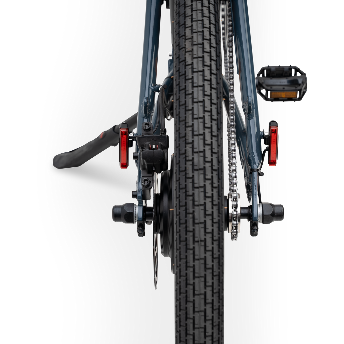 Rear view of The Otis E-Bike in Marine Blue showing tire tread, rear hub motor, and integrated safety lights