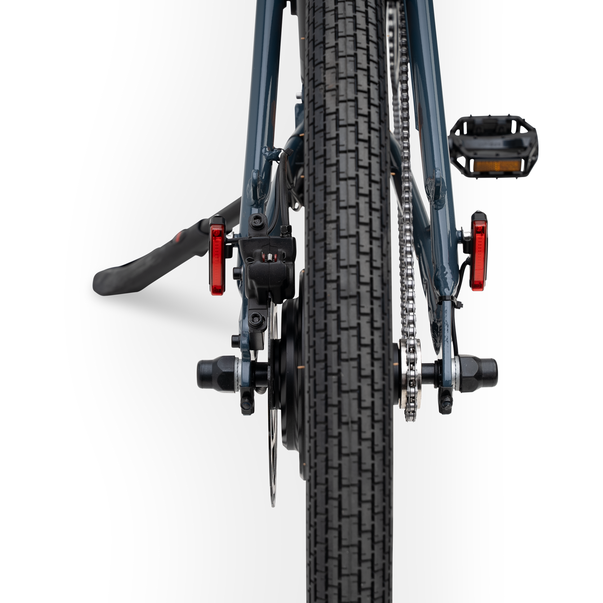 Rear view of The Otis E-Bike in Marine Blue showing tire tread, rear hub motor, and integrated safety lights